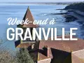Vue panoramique de Granville, avec la mer, la plage et des toits de tuiles. Idéal pour un week-end à Granville.