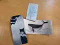 Trois gravures sur brique de lait : une femme, une baleine et une branche de chêne.