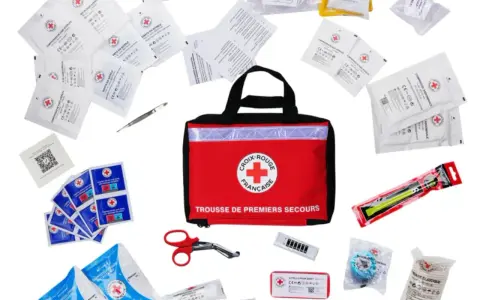 Trousse de premiers secours de la Croix-Rouge française, contenant compresses, gants, pansements et ciseaux. Idéal pour le contenu trousse pharmacie école.