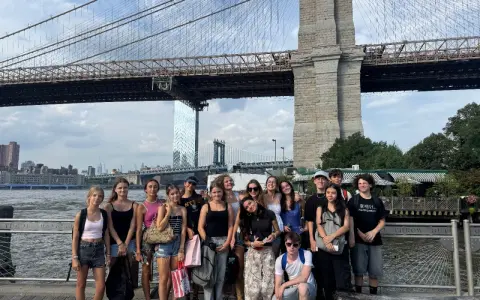 Groupe de jeunes devant le pont de Brooklyn à New York.