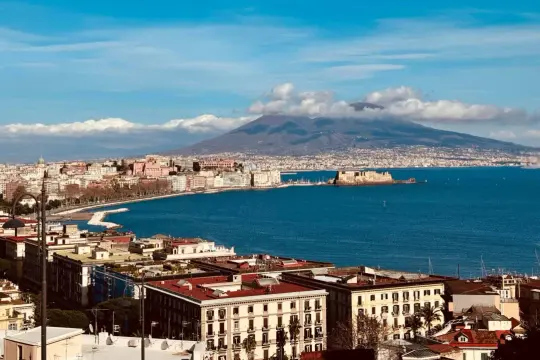 Vue panoramique de Naples avec le Vésuve en arrière-plan, un voyage inoubliable.