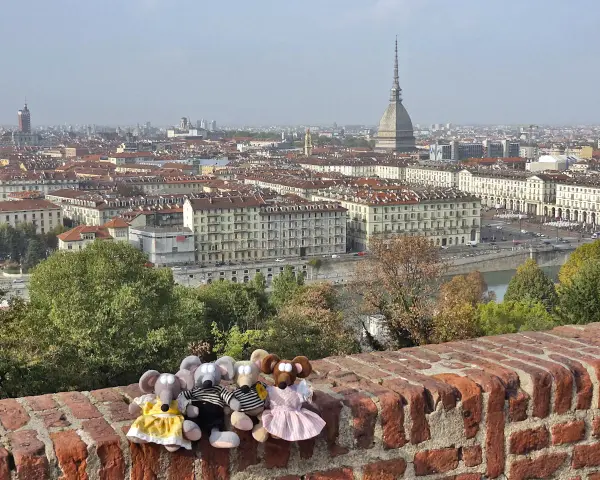 Des souris en peluche profitent de la vue panoramique sur Turin, parfait pour un séjour de 3 jours. La Mole Antonelliana domine le paysage urbain.