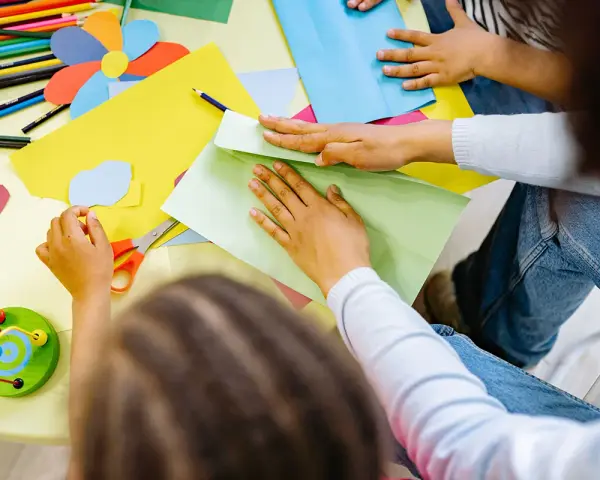 Exemple de projet d'animation en centre de loisirs : des enfants créent des formes colorées en papier.