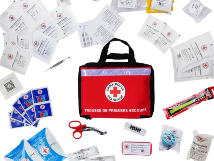 Trousse de premiers secours de la Croix-Rouge française, contenant compresses, gants, pansements et ciseaux. Idéal pour le contenu trousse pharmacie école.